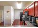 Kitchen with dark wood cabinets, stainless steel appliances, and hardwood floors at 655 Barshay Dr, Covington, GA 30016