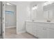Bathroom boasts double vanity, white cabinets, and tile flooring at 3404 Mount Olive Rd, Atlanta, GA 30344