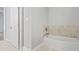 Bathroom features a bathtub with marble tile and grey walls at 3404 Mount Olive Rd, Atlanta, GA 30344