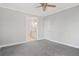 Primary bedroom with ceiling fan, en-suite bathroom access, and grey carpet at 3404 Mount Olive Rd, Atlanta, GA 30344