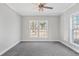 Well-lit bedroom with large window, ceiling fan, and grey carpet at 3404 Mount Olive Rd, Atlanta, GA 30344
