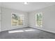 Well-lit bedroom featuring two large windows and grey carpet at 3404 Mount Olive Rd, Atlanta, GA 30344