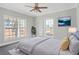 Spacious bedroom with ceiling fan, large windows, and grey carpet at 3404 Mount Olive Rd, Atlanta, GA 30344