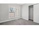 Bright bedroom with large window, carpet, and walk-in closet at 3404 Mount Olive Rd, Atlanta, GA 30344