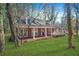 Brick home with a long porch, nestled among trees at 3404 Mount Olive Rd, Atlanta, GA 30344