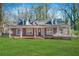 Brick house with front porch and landscaped lawn at 3404 Mount Olive Rd, Atlanta, GA 30344