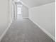Long hallway with grey carpet and doors to other rooms at 3404 Mount Olive Rd, Atlanta, GA 30344
