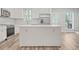 Modern kitchen island with white cabinets and countertops at 3404 Mount Olive Rd, Atlanta, GA 30344
