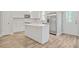Modern kitchen with white cabinets, island, and stainless appliances at 3404 Mount Olive Rd, Atlanta, GA 30344