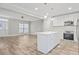 Open concept kitchen with white cabinets, island, and stainless steel appliances at 3404 Mount Olive Rd, Atlanta, GA 30344