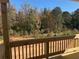 New wood deck overlooks undeveloped woodland; natural light filters through the surrounding trees at 316 Rodeo Dr, Auburn, GA 30011