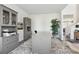 Home office featuring grey cabinetry, a large desk, and an accent rug on wood floors at 316 Rodeo Dr, Auburn, GA 30011