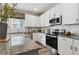 Kitchen featuring granite countertops, stainless steel appliances, white cabinets and subway tile backsplash at 316 Rodeo Dr, Auburn, GA 30011