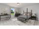 Well-lit main bedroom with a four-poster bed, desk, and neutral decor at 714 Ocmulgee Xing, Locust Grove, GA 30248