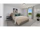 Stylish bedroom with a queen bed, bedside tables, and a window with a view of the outdoors at 714 Ocmulgee Xing, Locust Grove, GA 30248