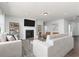 Bright living room with a fireplace, large TV, stylish furniture, and neutral colors for a cozy and inviting atmosphere at 714 Ocmulgee Xing, Locust Grove, GA 30248