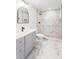 Bathroom featuring dual sinks, marble countertops, decorative mirrors, and a walk-in shower at 860 Gardner Sw St, Austell, GA 30168
