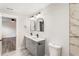 Bathroom featuring dual sinks, marble countertops, decorative mirrors, and a walk-in shower at 860 Gardner Sw St, Austell, GA 30168