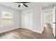 Bedroom features a ceiling fan, wood floors, a closet, and a window at 860 Gardner Sw St, Austell, GA 30168