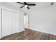 Bedroom features a ceiling fan, wood floors, and a closet at 860 Gardner Sw St, Austell, GA 30168
