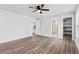Bright bedroom features a ceiling fan, wood floors, and an ensuite bathroom and closet at 860 Gardner Sw St, Austell, GA 30168