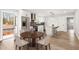 Open kitchen with white cabinets, island seating, stainless appliances and adjacent dining area at 860 Gardner Sw St, Austell, GA 30168