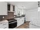 Modern kitchen features white cabinets, stainless steel appliances, and stylish backsplash at 860 Gardner Sw St, Austell, GA 30168