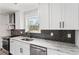 A beautifully renovated kitchen featuring granite countertops and stainless steel appliances at 860 Gardner Sw St, Austell, GA 30168