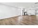 Open-concept living room with wood-look floors and a modern kitchen with stainless steel appliances at 860 Gardner Sw St, Austell, GA 30168