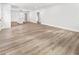 Spacious living room with wood-look flooring, neutral walls, and a view into the kitchen at 860 Gardner Sw St, Austell, GA 30168