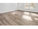 Bright living room featuring light wood-look flooring and natural light from the windows at 860 Gardner Sw St, Austell, GA 30168