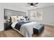 Beautifully staged main bedroom features a large bed, side tables and hardwood floors at 860 Gardner Sw St, Austell, GA 30168
