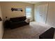 Spare bedroom with sofa, closet, and soft neutral carpet at 3885 Nixon Grove Dr, Douglasville, GA 30135