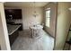 Light-filled dining area features a modern chandelier, wooden floors, and views to the backyard at 3885 Nixon Grove Dr, Douglasville, GA 30135