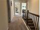 Upstairs hallway with carpet and access to multiple rooms at 3885 Nixon Grove Dr, Douglasville, GA 30135