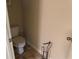 A small toilet room contains a toilet and a metal rack at 3885 Nixon Grove Dr, Douglasville, GA 30135