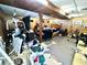 Basement area with wood paneled walls contains a bed, weight machine, and varied storage at 3928 Potomac Nw Dr, Kennesaw, GA 30144