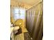 Bathroom featuring floral shower curtain, toilet, and a window at 3928 Potomac Nw Dr, Kennesaw, GA 30144