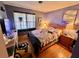 A bedroom featuring a wooden bed frame, dresser, and natural light from a window at 3928 Potomac Nw Dr, Kennesaw, GA 30144