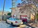 Rear view of the home with a detached garage and a brick exterior at 3928 Potomac Nw Dr, Kennesaw, GA 30144