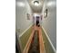 Hallway with two-tone paint, wood floors, and vintage decor, leading into the rest of the home at 3928 Potomac Nw Dr, Kennesaw, GA 30144