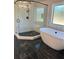 Modern bathroom with a large walk-in shower and a free-standing soaking tub at 4010 Sierra Vista Cir, Cumming, GA 30040