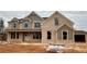 Two story home with beige and brick exterior finishes at 4010 Sierra Vista Cir, Cumming, GA 30040