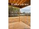 Covered patio overlooking serene lake and trees at 4010 Sierra Vista Cir, Cumming, GA 30040
