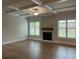 Spacious living room featuring hardwood floors, a fireplace, and coffered ceilings at 4010 Sierra Vista Cir, Cumming, GA 30040