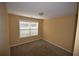 Simple bedroom with neutral carpeting and a window at 7765 Haynes Park Cir, Lithonia, GA 30038