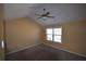 Bright bedroom with neutral carpeting and a ceiling fan at 7765 Haynes Park Cir, Lithonia, GA 30038