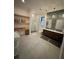 Bathroom boasting open shelving, double vanity, and glass enclosed shower at 839 Braselton Hwy, Lawrenceville, GA 30043