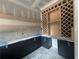 Unfinished butler's pantry has dark lower cabinets, a wine rack, and floating shelves at 839 Braselton Hwy, Lawrenceville, GA 30043