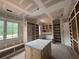 Unfinished dressing room with custom shelves and a work island at 839 Braselton Hwy, Lawrenceville, GA 30043